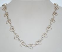 A silver 925 heart linked necklace chain having a C clasp and adjustable length. Chain measures 16