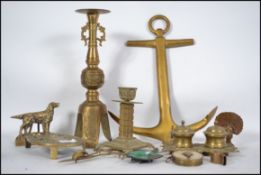 A collection of 19th and 20th century brass ware to include a peacock, an easel back English setter,