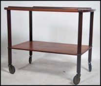 A good 1970's teak butlers trolley of Danish influence having crossbanded edged details with pierced