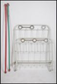 A pair of Victorian metal painted cast iron beds - ex military / hospital use being of tubular