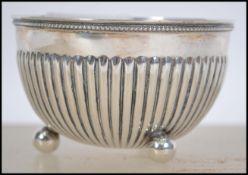 A VIctorian silver bowl raised on ball feet with reeded decoration. Hallmarks for Birmingham,