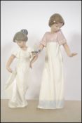 Two Nao female ceramic figurines.  One young girl raising her skirt with one hand; marked to base