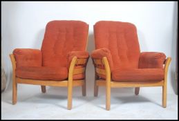 A pair of  Ercol Renaissance armchairs in golden dawn having stunning shaped frames with slat