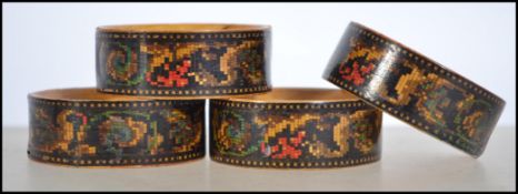 A matching set of 4 late Victorian tunbridge stickwork inlaid treen napkin rings.