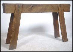 A rustic 19th century vintage solid oak farmhouse pig bench. The top of heavy thick cut plank form