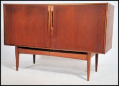 A 1970's Mcintosh of Kirkcaldy Scottish teak wood sideboard dresser in teak being rased on squared