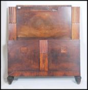 A 1930's Art Deco walnut single bed having tall panel headboard with embellished details complete