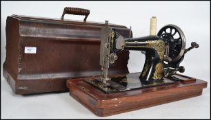 A good J.Collier and Sons Ltd sewing machine in original case with carry handle intact and some