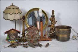 A collection of vintage items to include lamps, a brass adjustable shaving mirror, two cuckoo