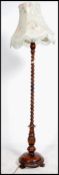 An Edwardian fruitwood standard lamp  having a stunning barley twist column with shade surmounted