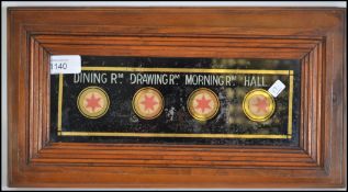 An Edwardian servants bell casing / butlers call box with a wooden casing and glass front with sighs