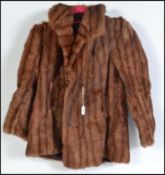 A ladies vintage, short length caramel muskrat fur coat / jacket with a two place hook and eye