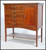 An Edwardian mahogany music cabinet. Having a bank of five drawers with adjoining cupboard. Raised