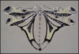 An Art nouveau silver and enamel set brooch in the form of a dragon fly having pin verso. Total