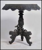 A 19th century intricately carved Anglo Indian Padouk occasional table, carved with birds, pierced