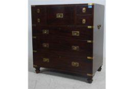 A 20th century antique style mahogany and brass bound cocktail cabinet in the form of a campaign