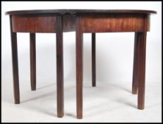 A pair of Georgian mahogany demi lune console hall tables, both raised on sqaured legs with fitted