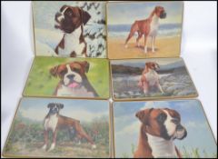Two cases of  unused table placemats from The Danbury Mint depicting Boxer Dogs. Each placemat
