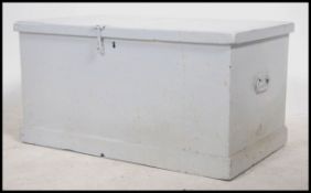 A 19th century painted pine blanket box, having a  hinged lid with hand made hinges opening to