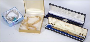 A collection of items to include a 925 gilded sili