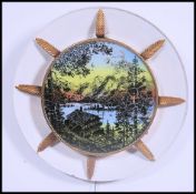 A retro mid century wall light with Scandinavian scene with backlight in plastic and gilded frame