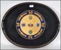 A good quality oval butlers tray having a fret pierced gallery surround and a central armorial