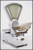 A set of vintage Avery white enamelled, triangular shaped shop counter scales with stainless steel