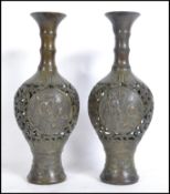 A pair of believed 19th century Chinese fret pieced bronze Gu vases, each with a central panel of