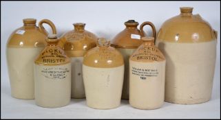 A group of seven early 20th century glazed ceramic stone ware beer / cider flagons of mostly Bristol