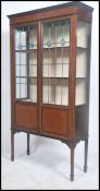 An Edwardian mahogany and satinwood cross banded display cabinet, with a raised back, above two