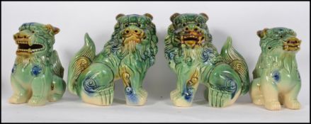 Two pairs of mid 20th century ceramic dogs of fu  - fu-dogs having been purchased by the vendor 45