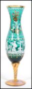 An unusual 20th century Mary Gregory type green glass and gilt cameo vase - goblet being raised on