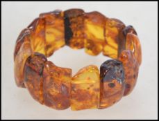 A vintage 20th century amber  plaque expanding bracelet, the plaques with inclusions