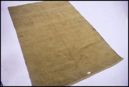 A 20th century contemporary Habitat floor rug in green having a square knotted thread with tassled