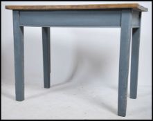 An early 20th century painted pine shabby chic farmhouse kitchen cottage dining table raised on