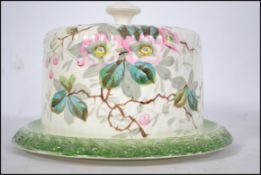 A 19th century Victorian ceramic circular cheese dish and base with hand painted  flower and
