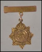 A 9ct gold George VI miniature medal brooch and bar with pin verso. Total weight 3.6g