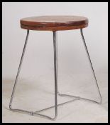 A 1960's chrome and wooden dot stool. The circular wooden top raised on tubular metal wire worked