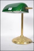 A 20th century contemporary green glass and brass bankers desk lamp having glass rectangular shade