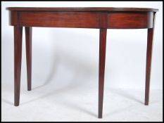 A 19th century Georgian mahogany demi lune console hall table. Raised on squared legs with fitted