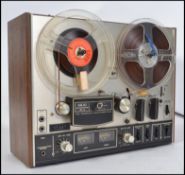 An original vintage Akai 4000DS model reel to reel tape recorder player set within original wooden