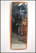 A 20th century teak atomic style wall mirror of rectangular form having hanging chain etc
