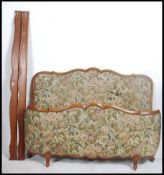 An early 20th century French corbeille bed with chenille upholstered head and footboard united by