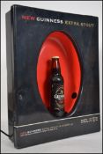 A retro point of sale advertising illuminated shop sign for Guinness. Having a revolving illuminated