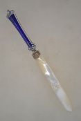 A silver hallmarked enamel and mother of pearl letter opener. The enameled handle having a blue