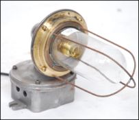 A 20th century Industrial cast metal heavy set bulkhead / dairy lamp with caged pendant style bulb