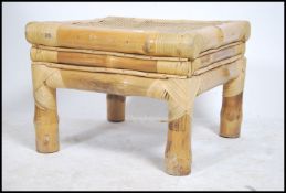 A 20th century bamboo and cane work coffee / occasional table being constructed from a bamboo frame