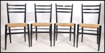 A set of 4 mid century ebonised and rattan weave retro dining chairs in the manner of Gio Ponti. The