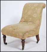 A Victorian mahogany ladies nursing chair being raised on turned legs with serpentine shaped
