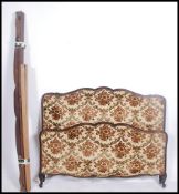 An early 20th century French corbeille bed with chenille upholstered head and footboard united by